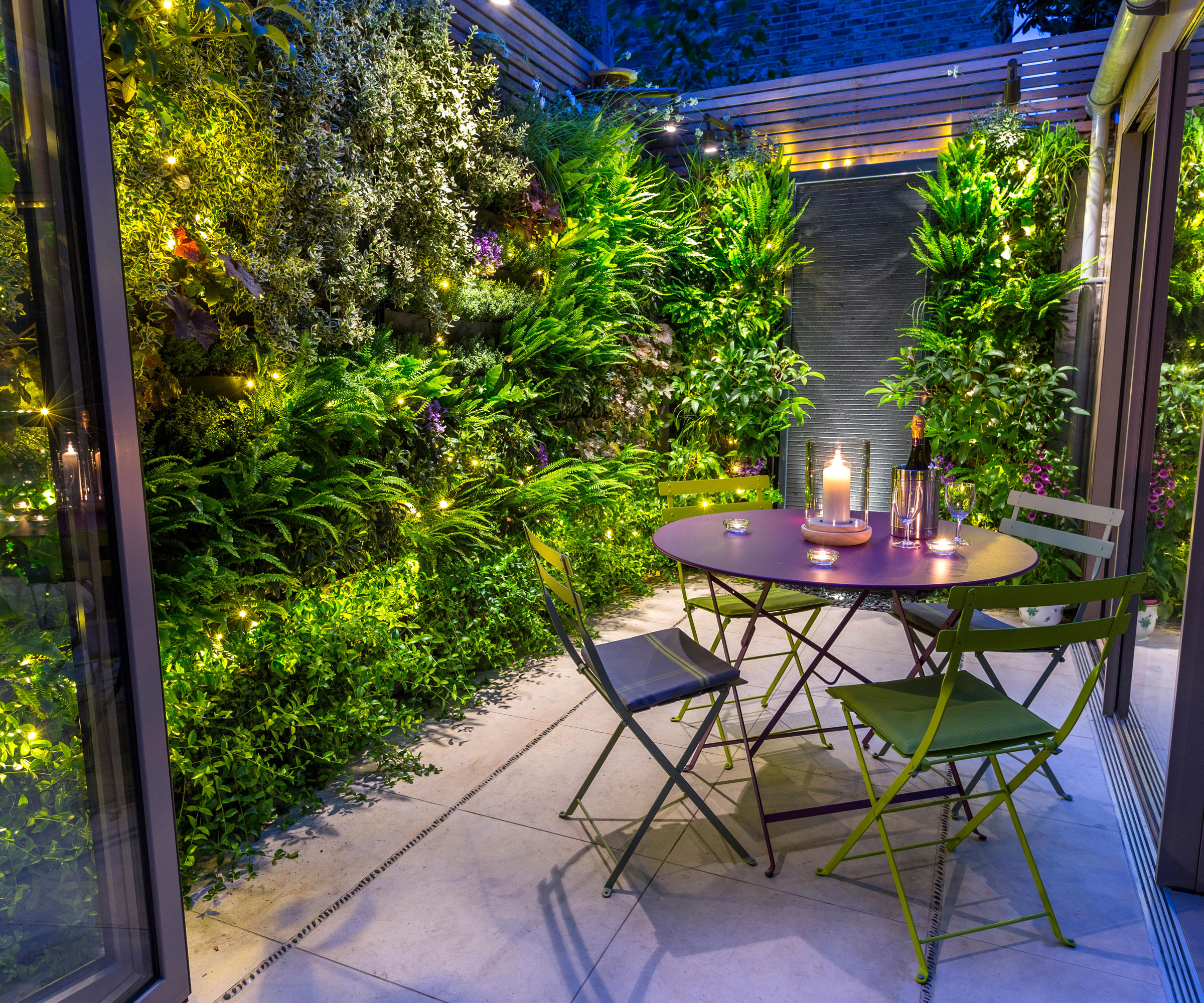 living wall with small paved patio and bistro set