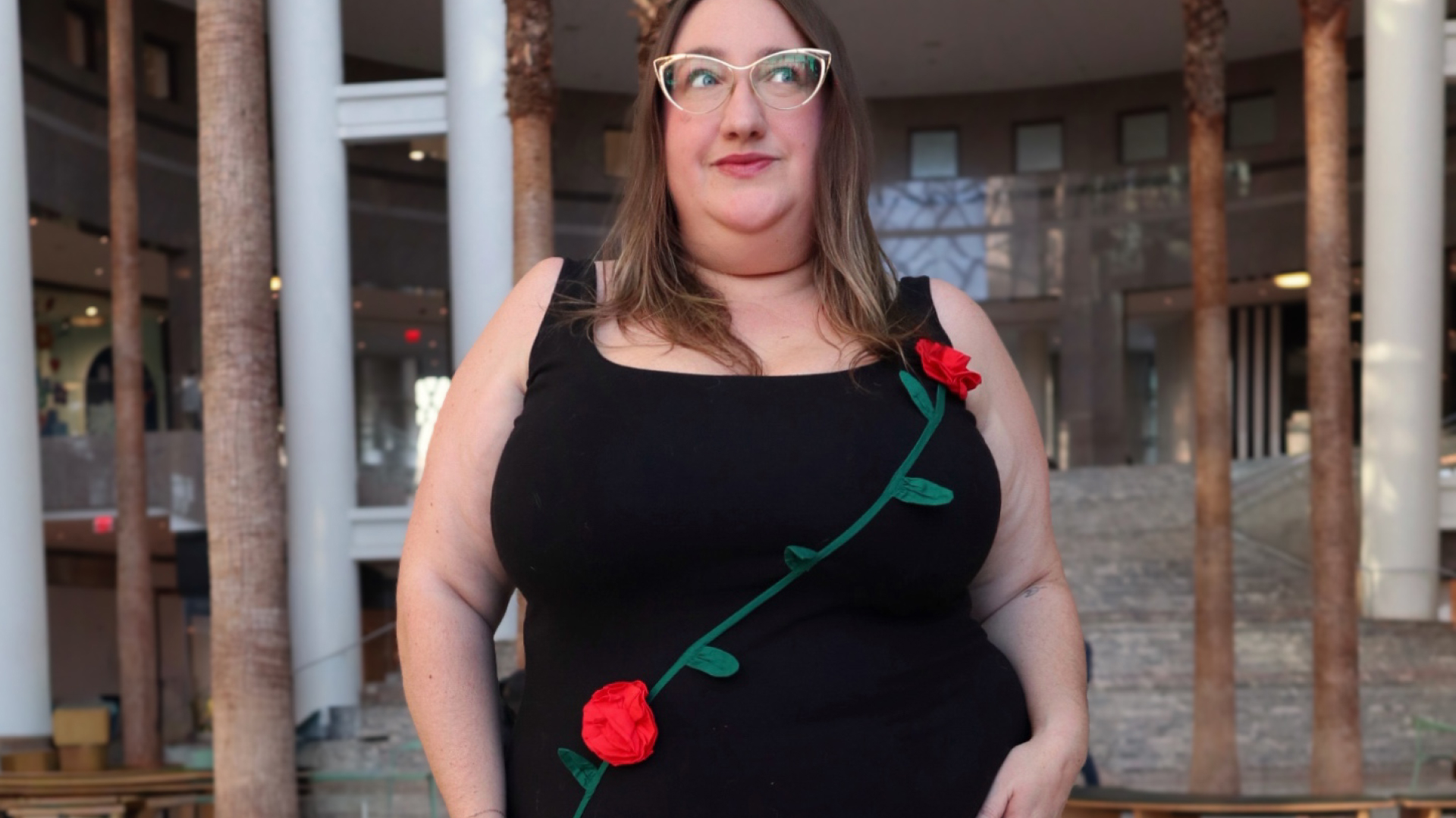 Sarah Chiwaya wearing a LBD with red rosettes