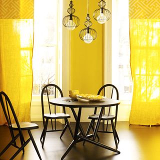 dining room with yellow curtain