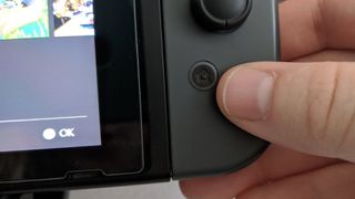 Home button on Nintendo Switch.