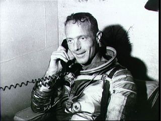 Astronaut M. Scott Carpenter, prime pilot for the Mercury-Atlas 7 (MA-7) mission, talks with President John F. Kennedy via radio-telephone from aboard the carrier U.S.S. Intrepid. Carpenter was recovered by a helicopter and taken to the U.S.S. Intrepid after a 4 hour and 56 minute mission in space.