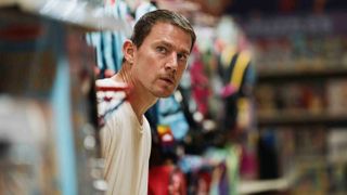 Jeffrey Manchester (Channing Tatum) peers around a Toys 'R' Us shelf in a scene from "Roofman"