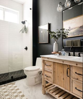 modern bathroom with dark grey wall, wooden washbasin and white shower