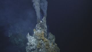 A "black smoker" on the sea floor belches dark plumes of heated water that is rich in sulfur.