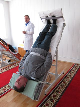 Italian astronaut Paolo Nespoli of the European Space Agency takes a spin on a tilt bed to prepare his body for spaceflight during the ISS Expedition 26/27 missions in 2010/2011.