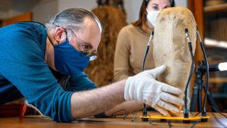 Carol Ann Barsody and Frederic Gleach examine the over 1,500-year-old mummy bird.