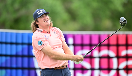 Neal Shipley watches a tee shot with a driver