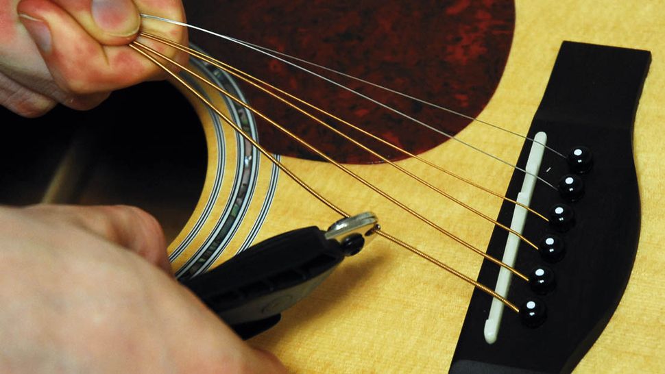 Guitar setup how to remove bridge pins on an acoustic guitar MusicRadar