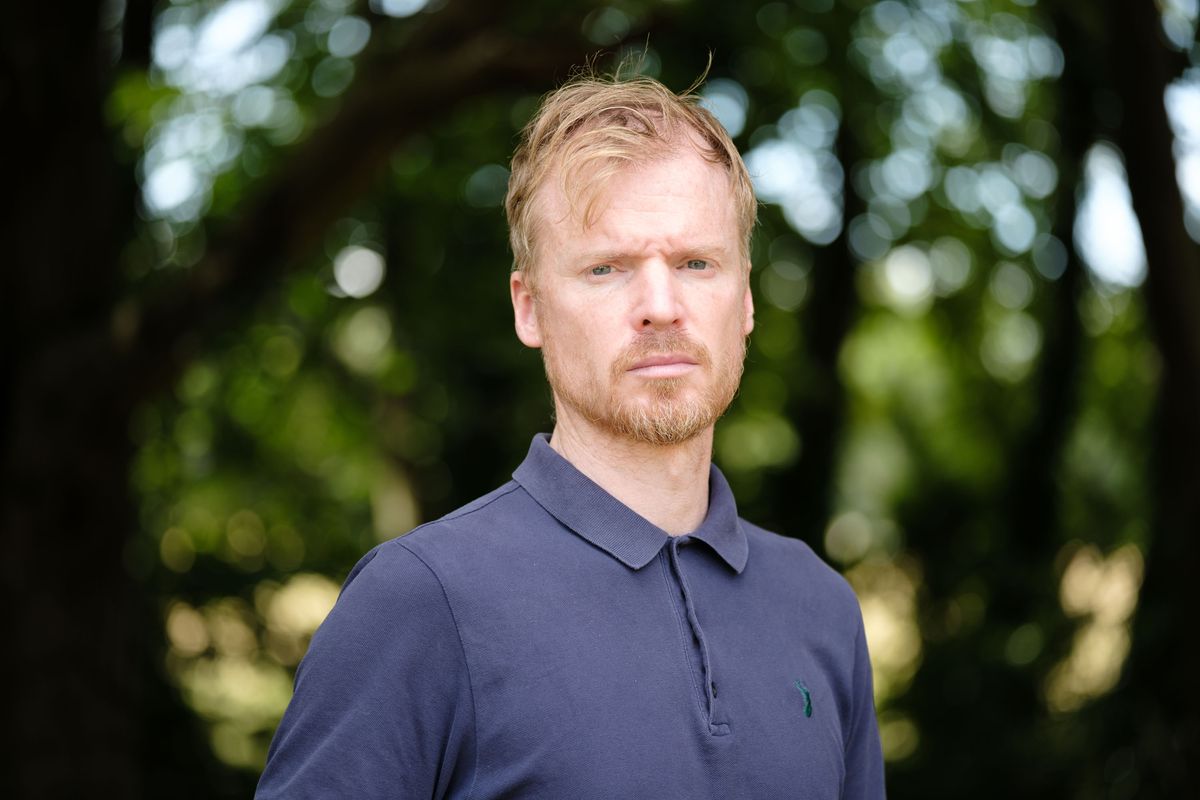 Viltrox AF 90mm F2.2 EVO lens image gallery: upper body portrait of a man with backlit trees behind him