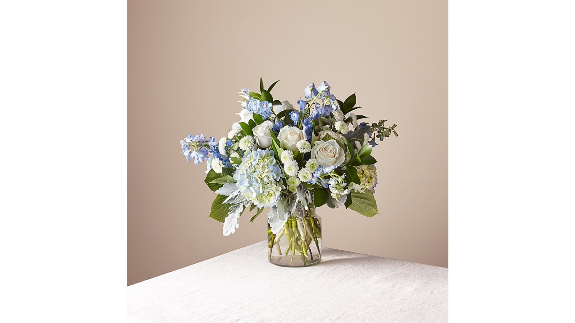 A bouquet of blue delphiniums, hydrangeas, and white roses, for the best flower delivery services.