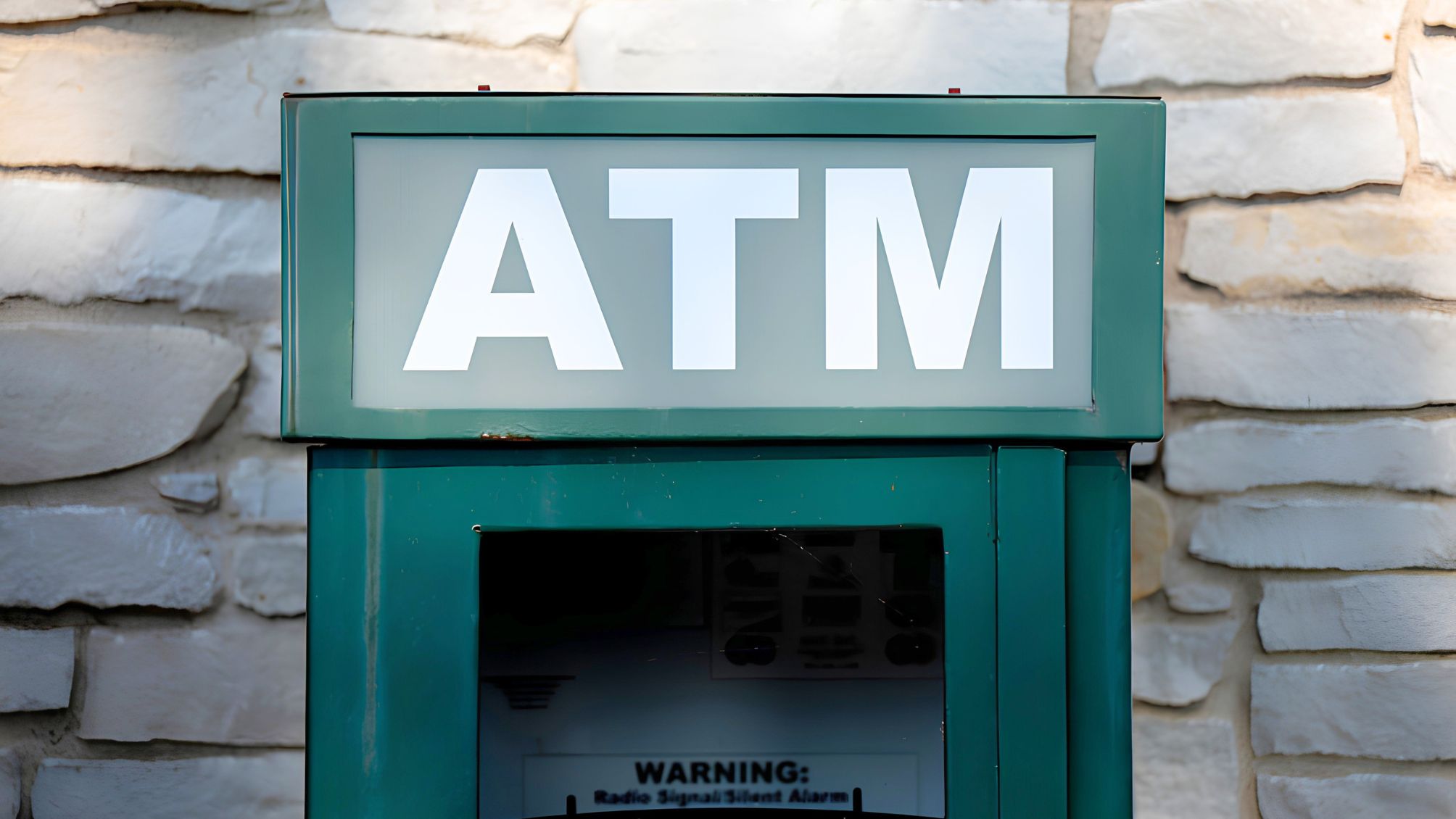 An automated teller machine is seen at the entrance to a bank office building in Chicago, Illinois