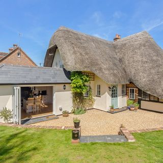 thatched house garden with grass