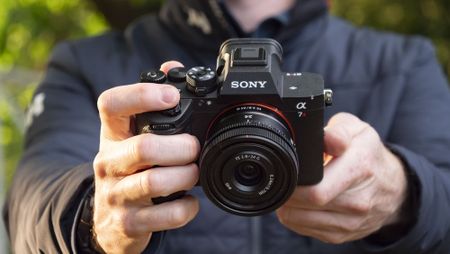 Sony A7R VI camera with 24mm F2.8 lens attached, in user's hands