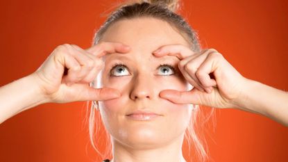 Woman practising face yoga