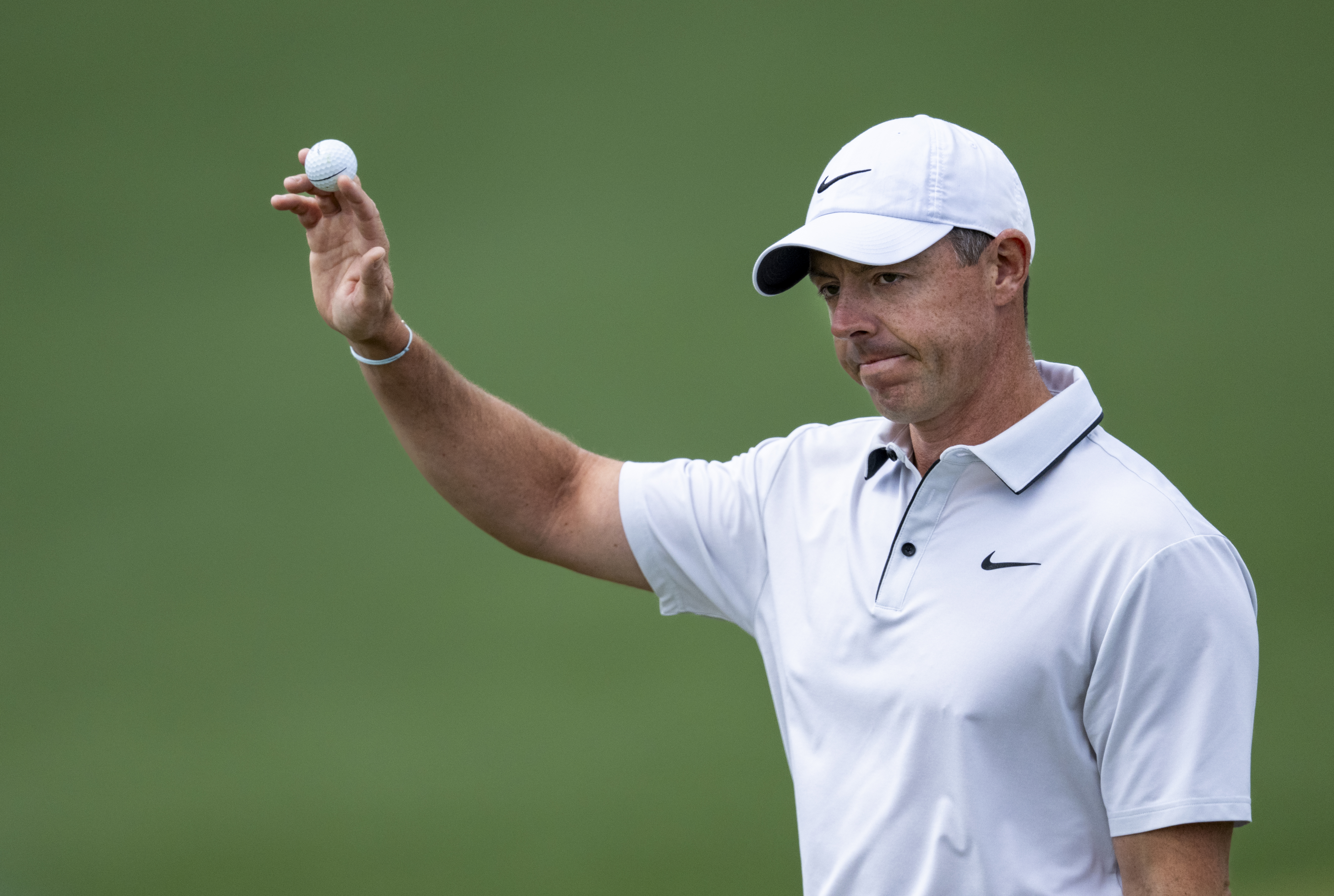 Rory McIlroy acknowledges the crowd by holding up his golf ball