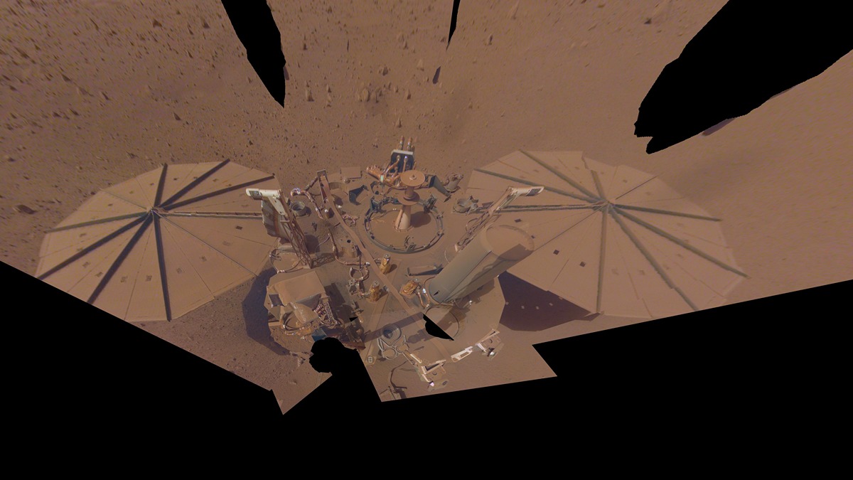 a spacecraft with solar panels absolutely covered in mars dust