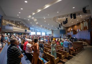 A congregation enjoys engulfing sounds from L-Acoustics.
