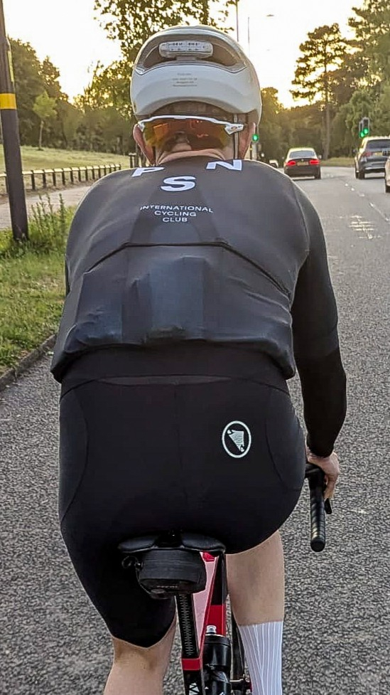 A rider in a black PNS Mechanism jersey