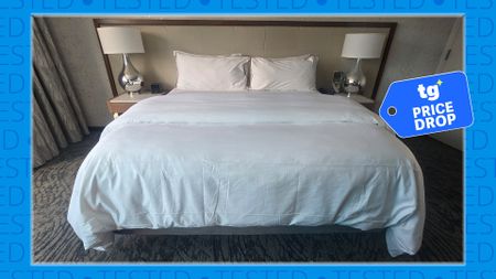 The Westin Heavenly Bed in a Westin Hotel room. It's surrounded by a blue barrier saying 'tested'. On the right hand side is a Tom's Guide price drop deals badge