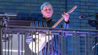 Jack White performs from a balcony on Marshall Street to crowds of people following his in store performance and opening of Third Man Records Store