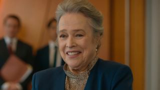 Kathy Bates smiles in conversation while standing in a conference room in Matlock.