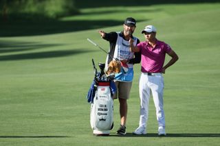 Morikawa speaks about a shot with his caddie