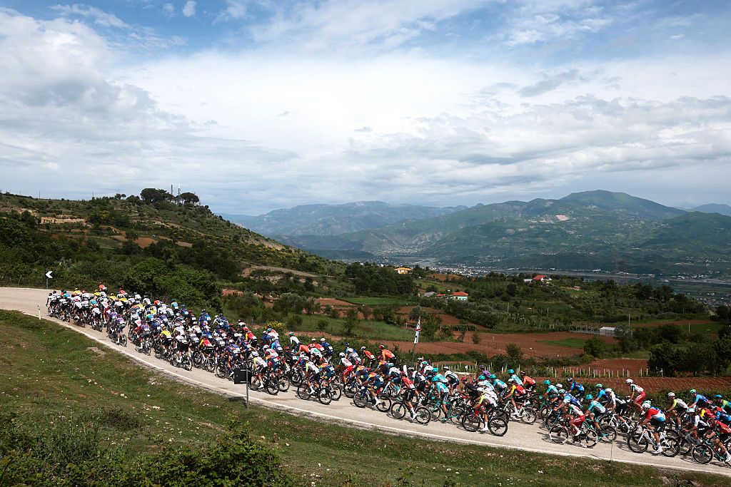 The pack rides in an ascent during the first stage of the 108th Giro d'Italia cycling race, 160km from Durres to Tirana in Albania, on May 9, 2025. (Photo by Luca Bettini / AFP)