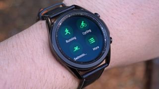 A Samsung Galaxy Watch 3 on someone's wrist, displaying exercise modes