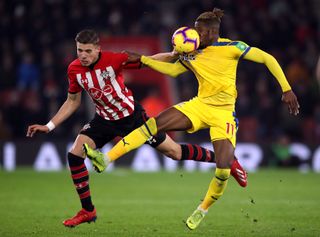 Wilfried Zaha takes a ball to the face in a battle with Southampton's Jan Bednarek