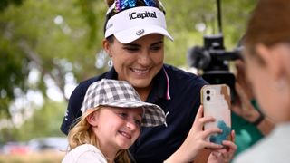 Lexi Thompsn poses with a young fan