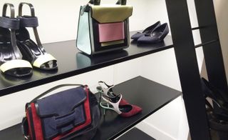 Colorful handbags and shoes on a wooden installation