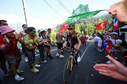 Sepp Kuss rides through a throng of fans at the Tour de France 2023