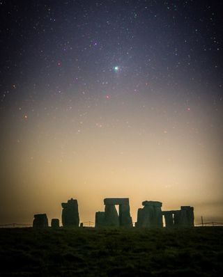 Comet C/2022 E3 (ZTF) glows above Stonehenge.