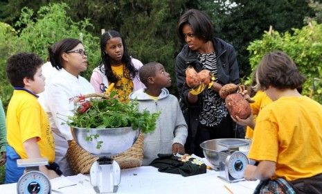 Michelle Obama and local D.C. fifth graders harvest the White House&amp;#039;s vegetable garden including sweet potatoes weighing up to four pounds.