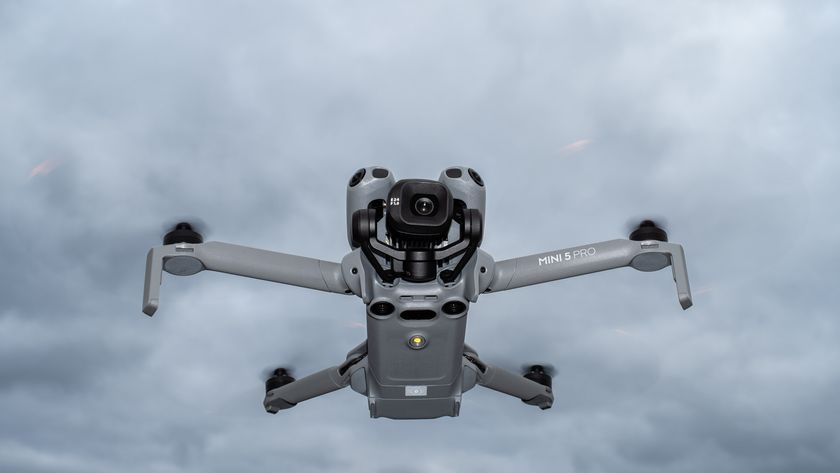 DJI Mini 5 Pro in flight against a cloudy sky