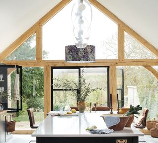 Modern country kitchen with vaulted ceiling and floor to ceiling glass door and panes