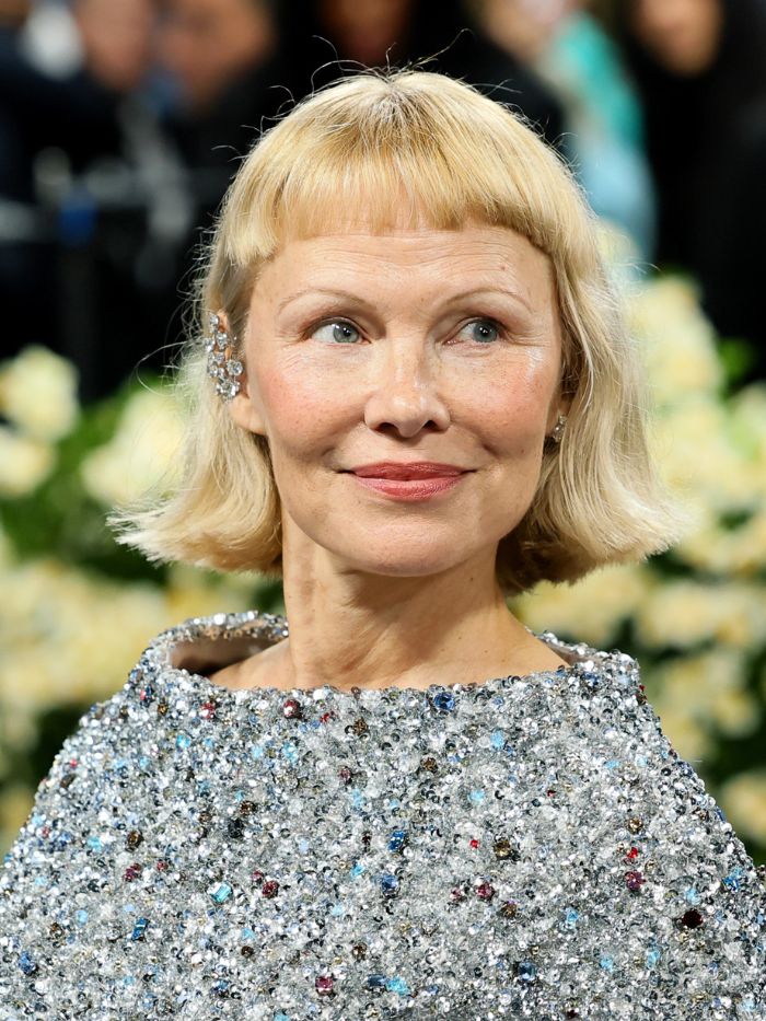 Pamela Anderson attends the 2025 Met Gala with a micro fringe hairstyle