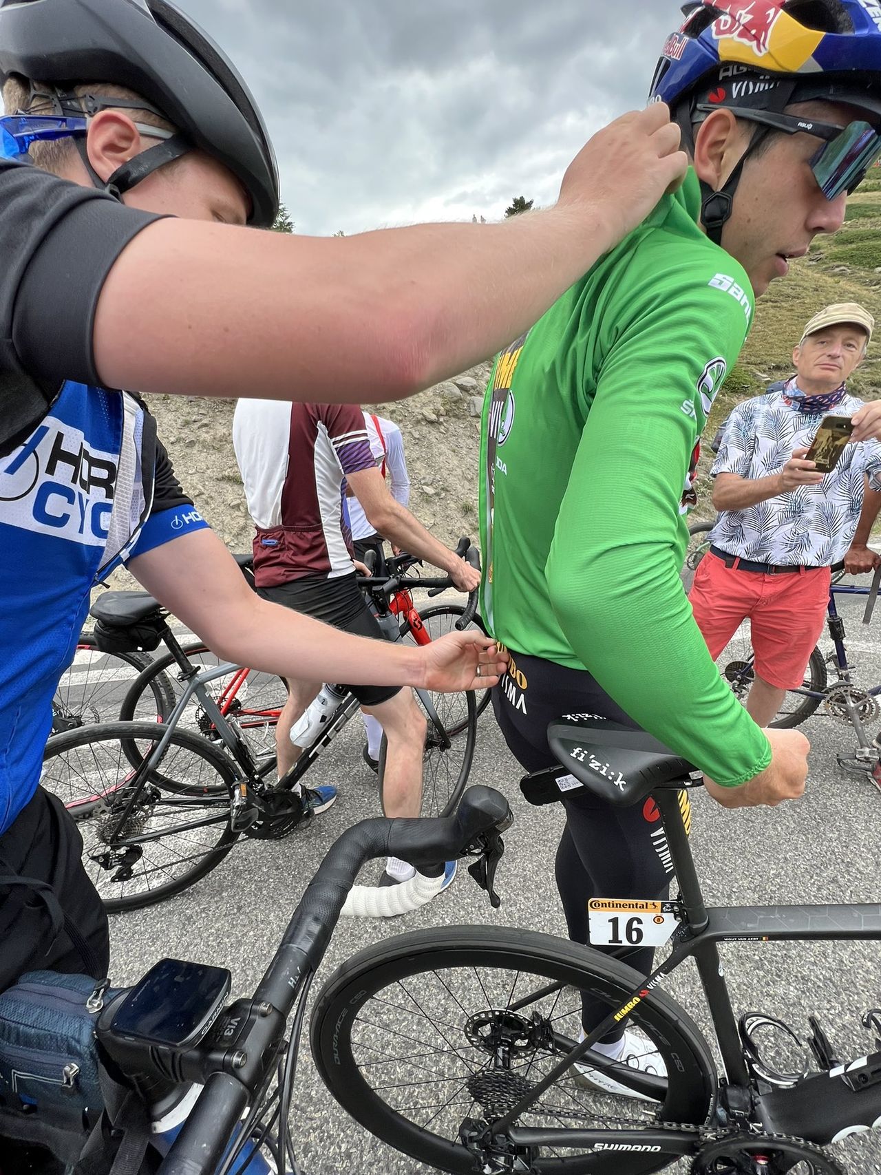 Wout van Aert (Jumbo-Visma) gets help fixing a flat tyre from some fans after stage 11 of the Tour de France
