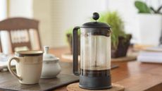 How to clean a French press: Bodum Brazil French Press on a table with a cup of coffee beside it 