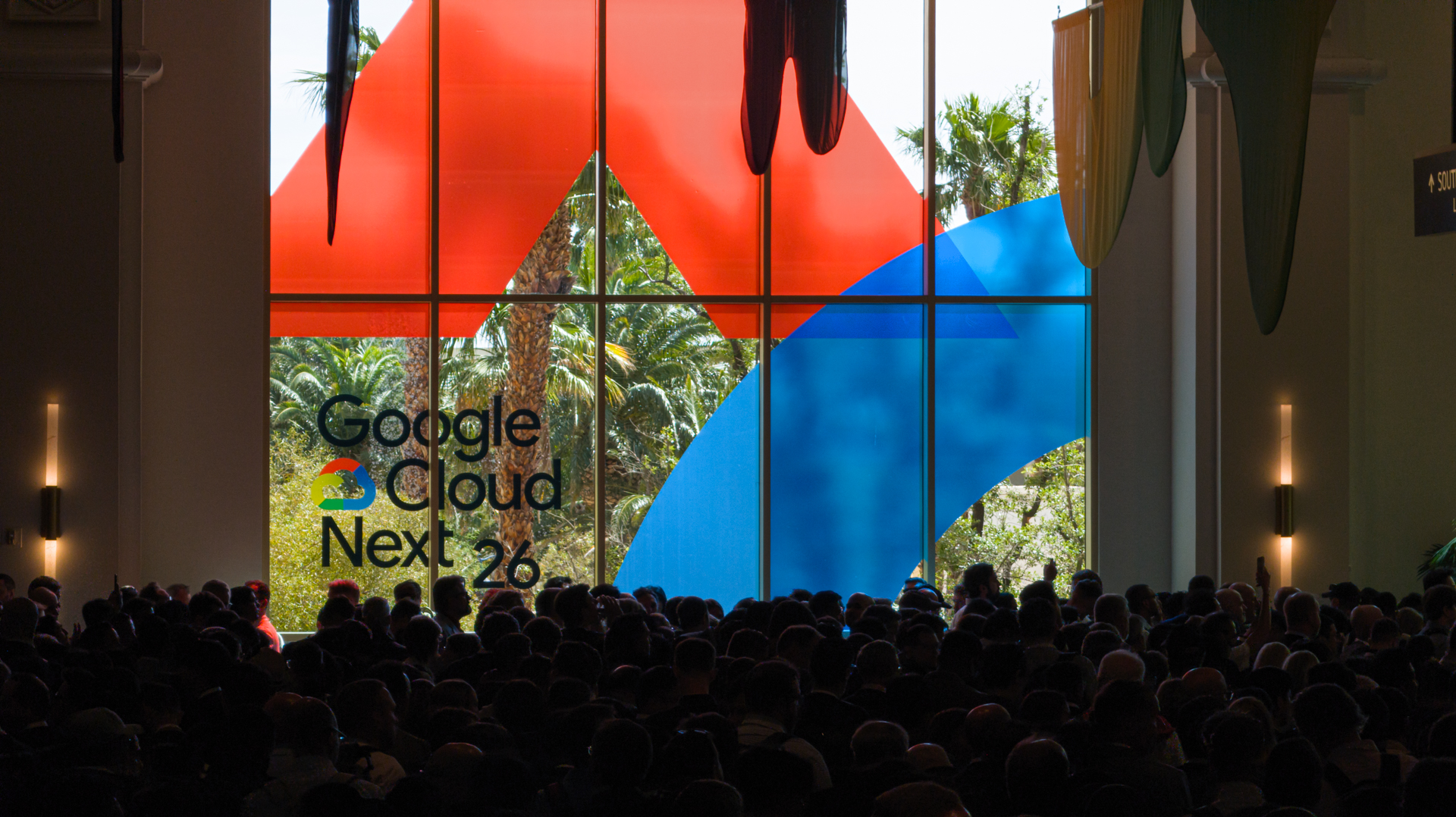 Attendees fill the hall at Google Cloud Next 2026, with the logo visible in large print on a window looking out on the Mandalay Bay Resort beach area.