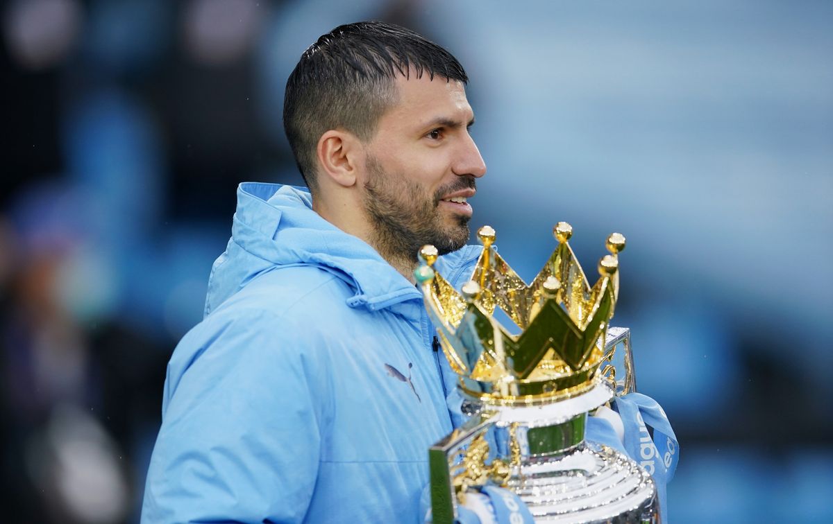 Argentine striker Sergio Aguero holding the Premier League trophy while playing for Manchester City