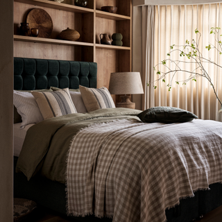 a green upholstered ottoman bed with gingham bed 