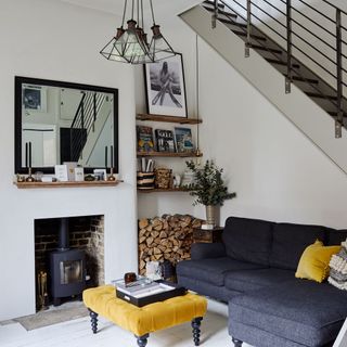 Living room with mustard accents and a dark blue sofa