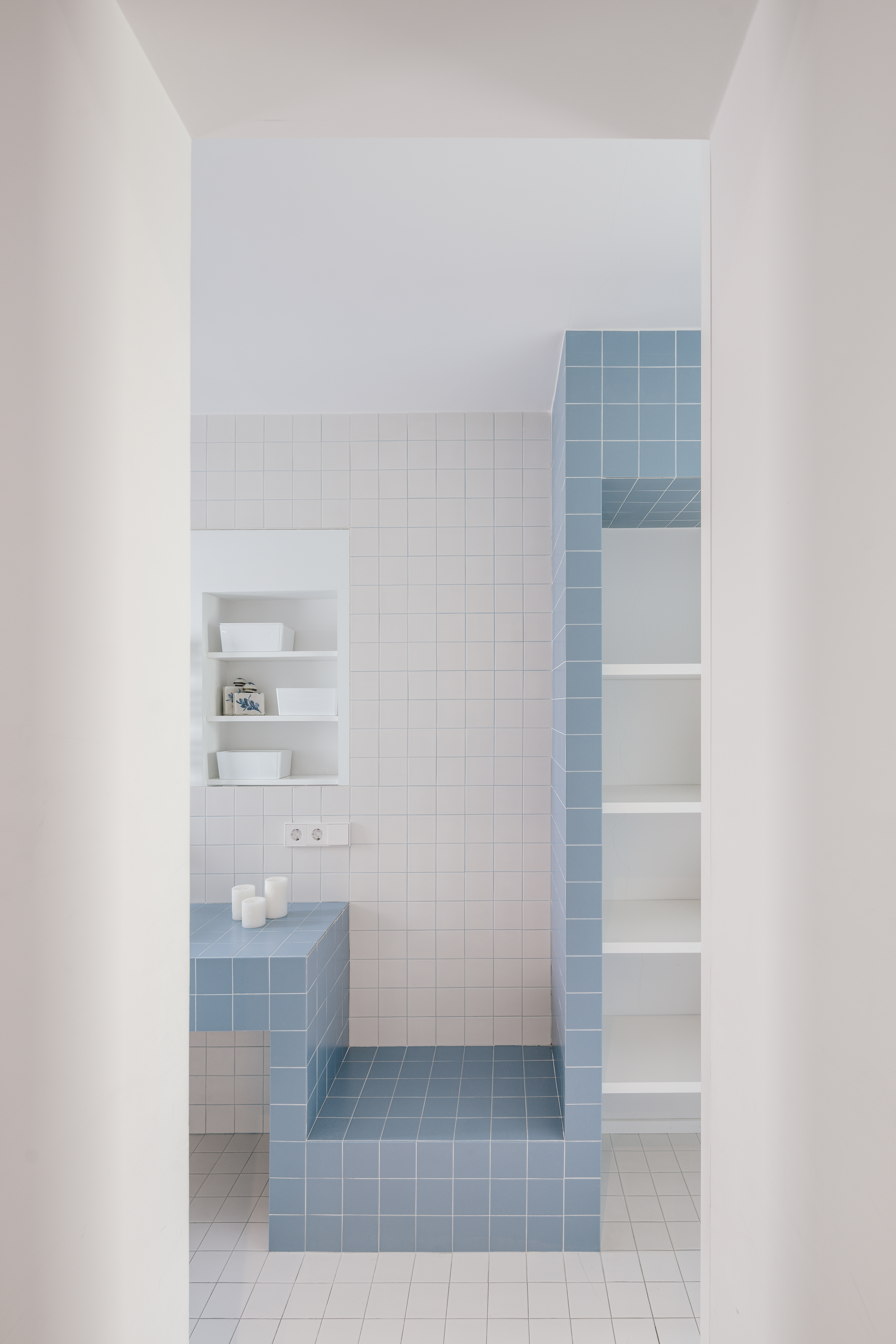 A bathroom in small blue and white square tiles
