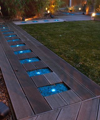 decking path with inset lights and coloured gravel