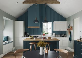 panelled kitchen with sloped roof, navy blue island and white cabinet