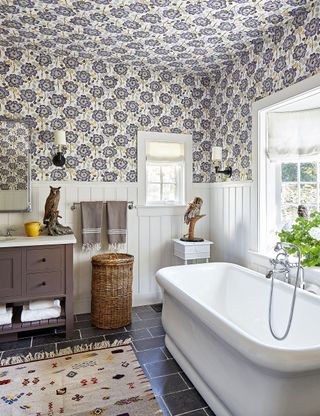Small bathroom with patterned wallpaper on wall and ceiling
