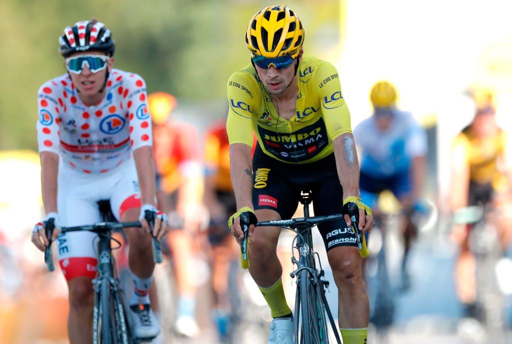 Team UAE Emirates rider Slovenias Tadej Pogacar wearing the best climbers polka dot jersey L and Team Jumbo rider Slovenias Primoz Roglic wearing the overall leaders yellow jersey cross the finish line at the end of the 18th stage of the 107th edition of the Tour de France cycling race 168 km between Meribel and La Roche sur Foron on September 17 2020 Photo by STEPHANE MAHE POOL AFP Photo by STEPHANE MAHEPOOLAFP via Getty Images