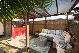 Backyard bar area made private by pergola