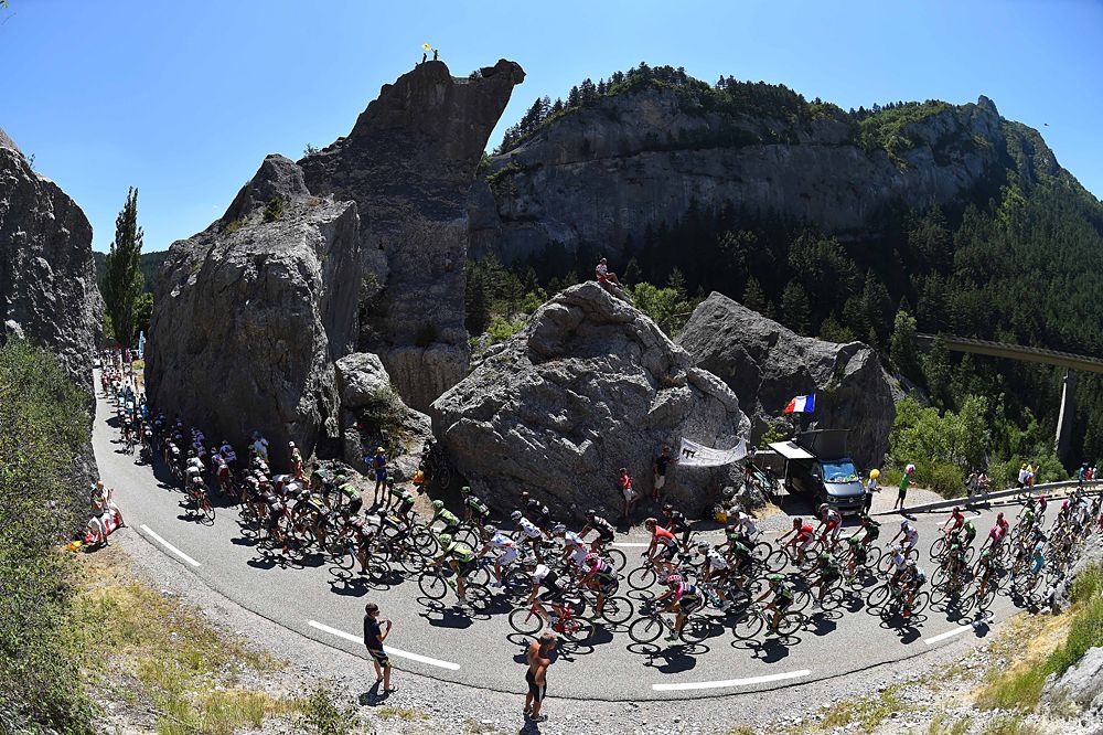 The peloton rounds a bend at the Tour de France
